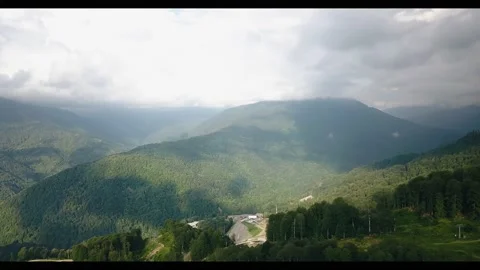 Cool mountains are covered with trees and with clouds above them Stock Footage 157159779