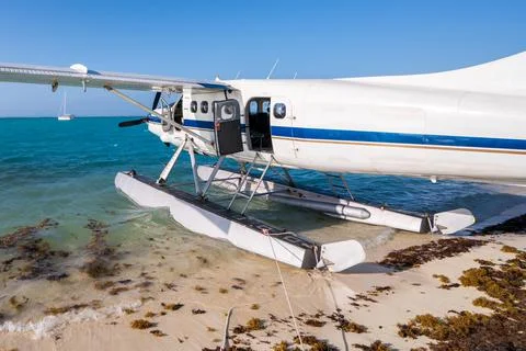 Cool old hydroplane with open door sitting on a sandy beach. Beautiful summer Stock Photos