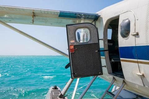 Cool old hydroplane with open door sitting on a sandy beach. Beautiful summer Stock Photos