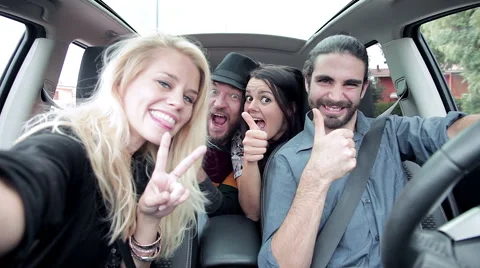 Cool people having fun laughing in car while taking selfie Stock Footage 61355426