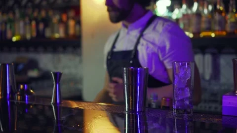 Cool professional caucasian bartender making a cocktail, shaking his shaker. Stock Footage 147033689