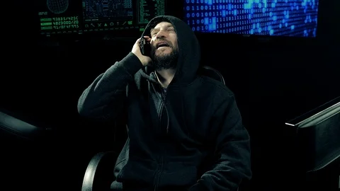 Cool programmer cracking code talking on the phone happy Stock Footage 86440938