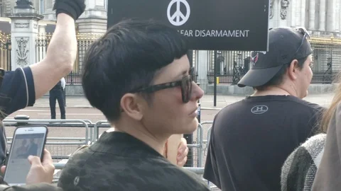 Cool Protester saying STOP TRUMPS NUCLEAR ARMS RACE at rally during Queen Visit Stock Footage 109205198