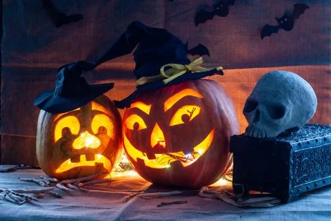 Cool pumpkins, Jack-o-lantern and skull, scary faces, Halloween background Stock Photos