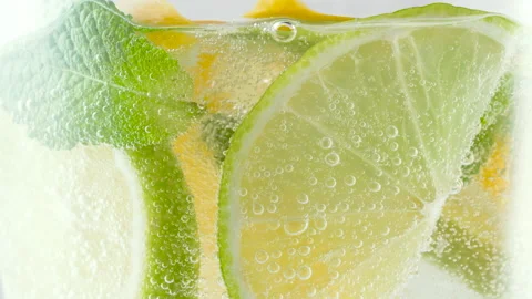 Cool refreshing homemade summer lemonade in a glass with ice cubes and fresh Stock Footage 154930223