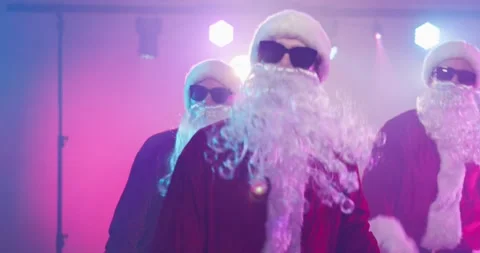 Cool Santa Claus dance group celebrating with gifts at a Christmas disco party Stock Footage 338095524