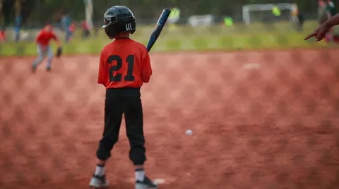 Cool shot of a Kid Batting at a Baseball Game Video stock 47499324