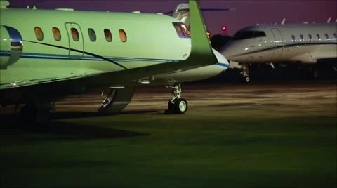 Cool shot of two planes parked at runway at airport Stock Footage 63474418