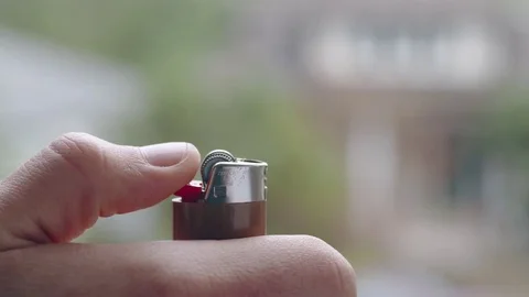 Cool slow-mo shot of flame bursting out of brown lighter Stock Footage 84489157