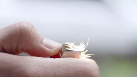 Cool slow-mo shot of flame bursting out of brown lighter Stock Footage 84489558
