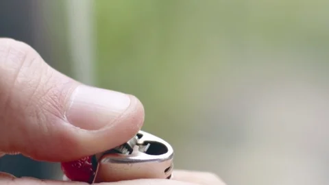 Cool slow-mo shot of flame bursting out of brown lighter Stock Footage 84489797