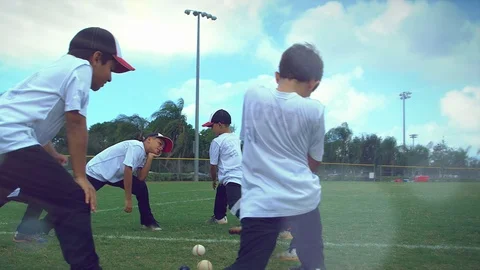 Cool slow motion of kids gathered together stretching during baseball practice Stock Footage 85642754