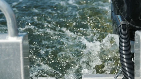 Cool splashes on the water from motor on the floating boat in the river Stock Footage 105882224