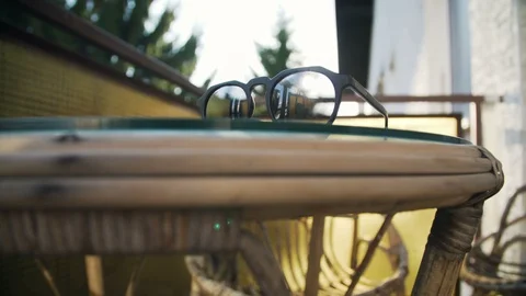 Cool sun glasses in sunset light on a balcony Video stock 102728519