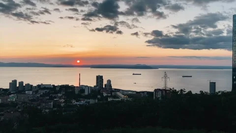 A cool sunset over a big sea city. A smooth panorama of the landscape. Stock Footage 282710039