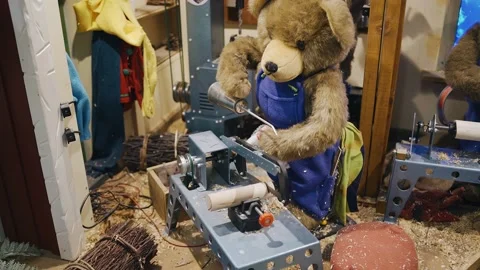 A cool toy bear stands behind a machine tool posing as a worker Stock Footage 154130149