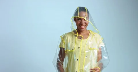 Cool transparent raincoat on an African model Stock Footage 81348809