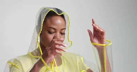 Cool transparent raincoat on an African model Stock Footage 81348870