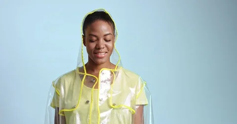 Cool transparent raincoat on an African model Stock Footage 81348906