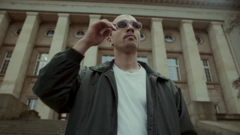 Cool young man in black jacket and sunglasses Stock Footage 258275076