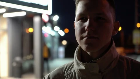 Cool young man with serious face starting to laugh on the street near the Видео 108184944
