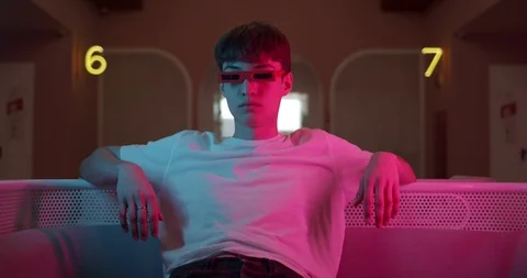 Cool Young Trendy Guy in White T shirt Wearing Stylish Glasses Sitting Relaxed Stock Footage 118594598