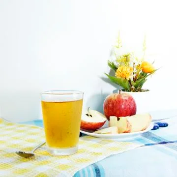 Cooled apple juice set on tablemat Stock Photos