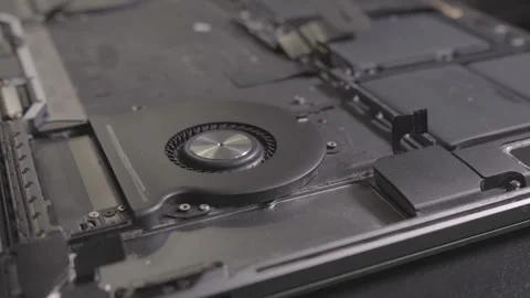 A cooler fan inside a MacBook pro laptop. Dolly shot Stock Footage 262539688