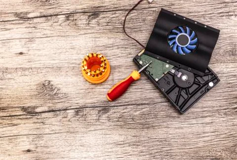 Cooler on hard disk with screwdriver bits. Stock Photos