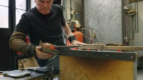 Cooling pad being used to mold hot glass Stock Footage 107897049