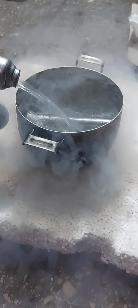Cooling a spare part, car beam kingpin, with liquid nitrogen. Garage work using Stock Footage 319757787