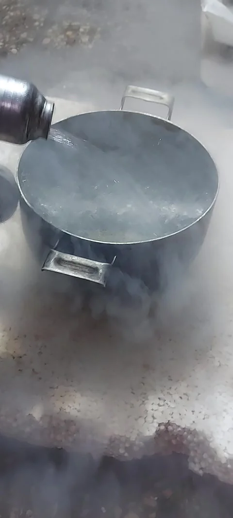 Cooling a spare part, car beam kingpin, with liquid nitrogen. Garage work using Stock Footage 322943774
