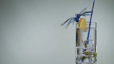 Cooling summer drink with lemon and kiwi rotate on a white background. Stock Footage 132489967