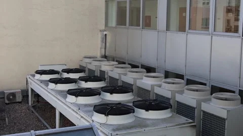 Cooling system units on the rooftop of a modern building with multiple industria Video stock 314519229
