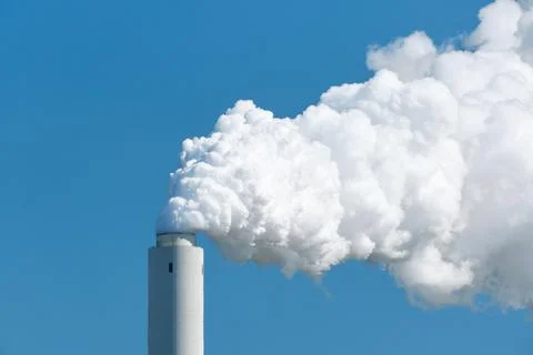 Cooling tower of an active coal power plant with thick steam Stock Photos
