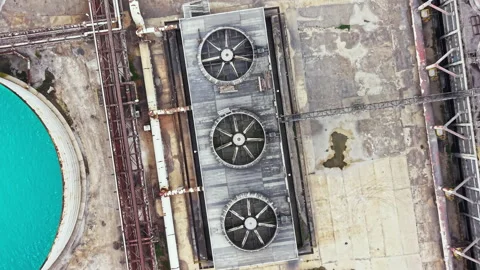 Cooling towers and industrial structures at a factory site near a body of water Stock Footage 341383856