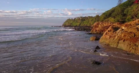 Coolum Beach drone tracking shot over waves and rocks Stock Footage 202053750