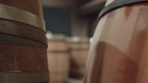 Cooper rolling away unfinished barrel, static close up Stock Footage 121325469