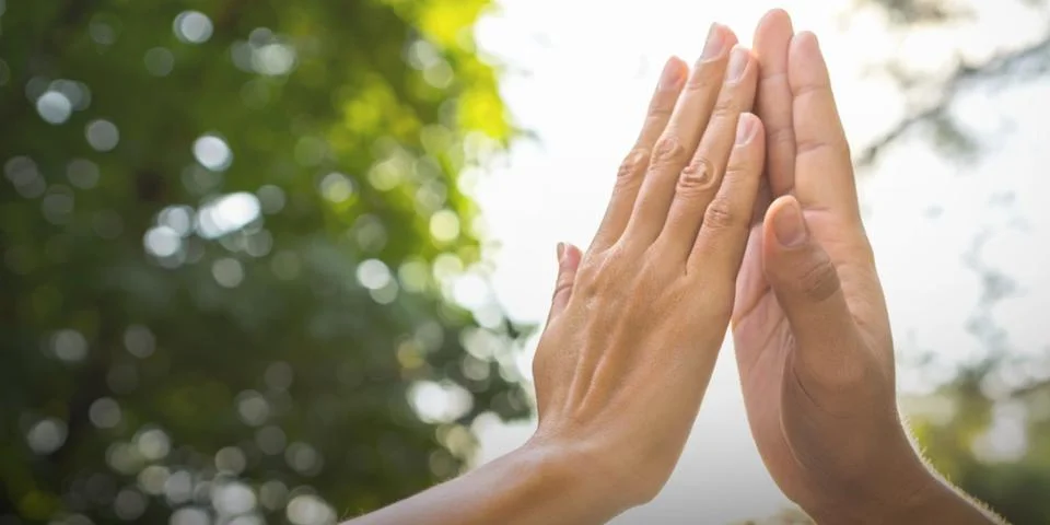 Cooperation and trust in teamwork with two hands gently touching Stock Photos