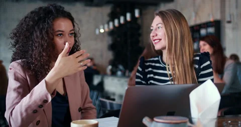 Cooperation concept. Two beautiful happy multiethnic business women talk 스톡 동영상 152575900