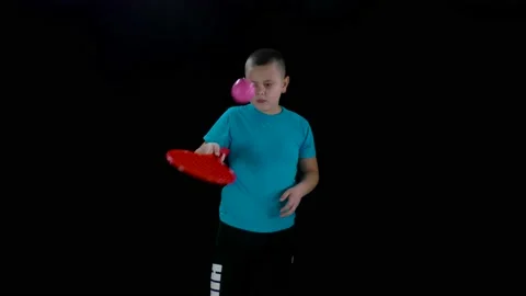 Coordination training boy in a blue t-shirt tosses the ball on a tennis racket Video stock 238504079