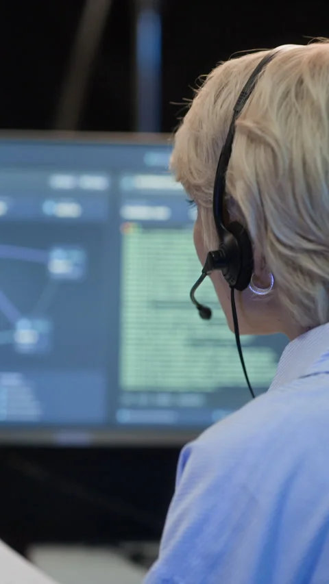 Coordinator Reporting Cybersecurity Data via Headset Working in Control Center Stock Footage 334936851