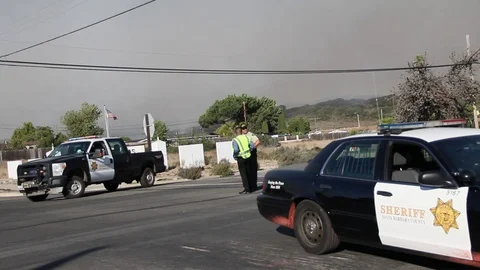 Cop car hit by red fire repellent chemical Stock Footage 114415078