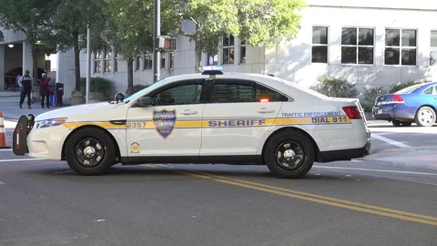 Cop car in street by intersection 2 Stock Footage 128446332