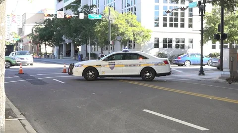 Cop car in street by intersection Stock Footage 128446312