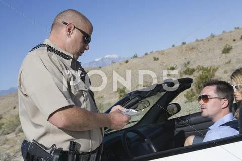 Cop Checking Man's License Stock Photos