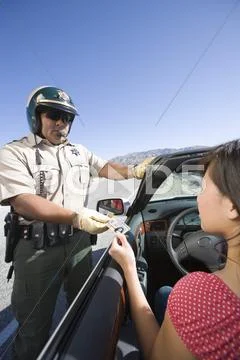 Cop Checking Woman's License Stock Photos