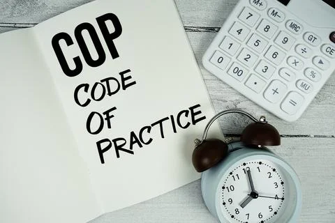 COP Code Of Practice text on paper notebook page with alarm clock and calcu.. Stock Photos