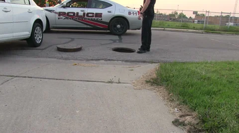 Cop at a open man hole 動画素材 38495419