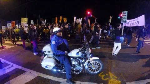 Cop protects Black Lives Matter protesters.  Video stock 56222267